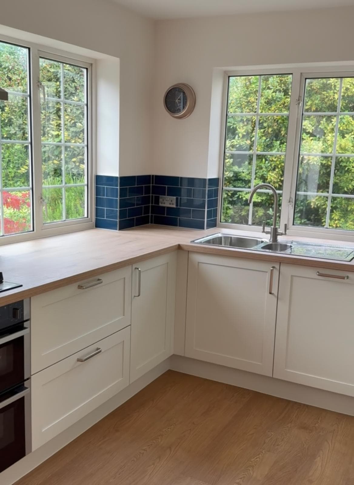 Cream shaker kitchen corner with blue metro tile splashback