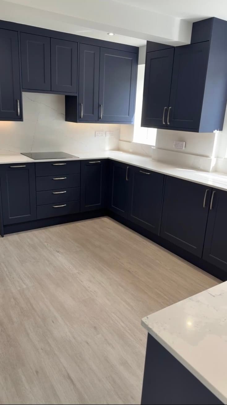 Navy shaker kitchen with white quartz worktops