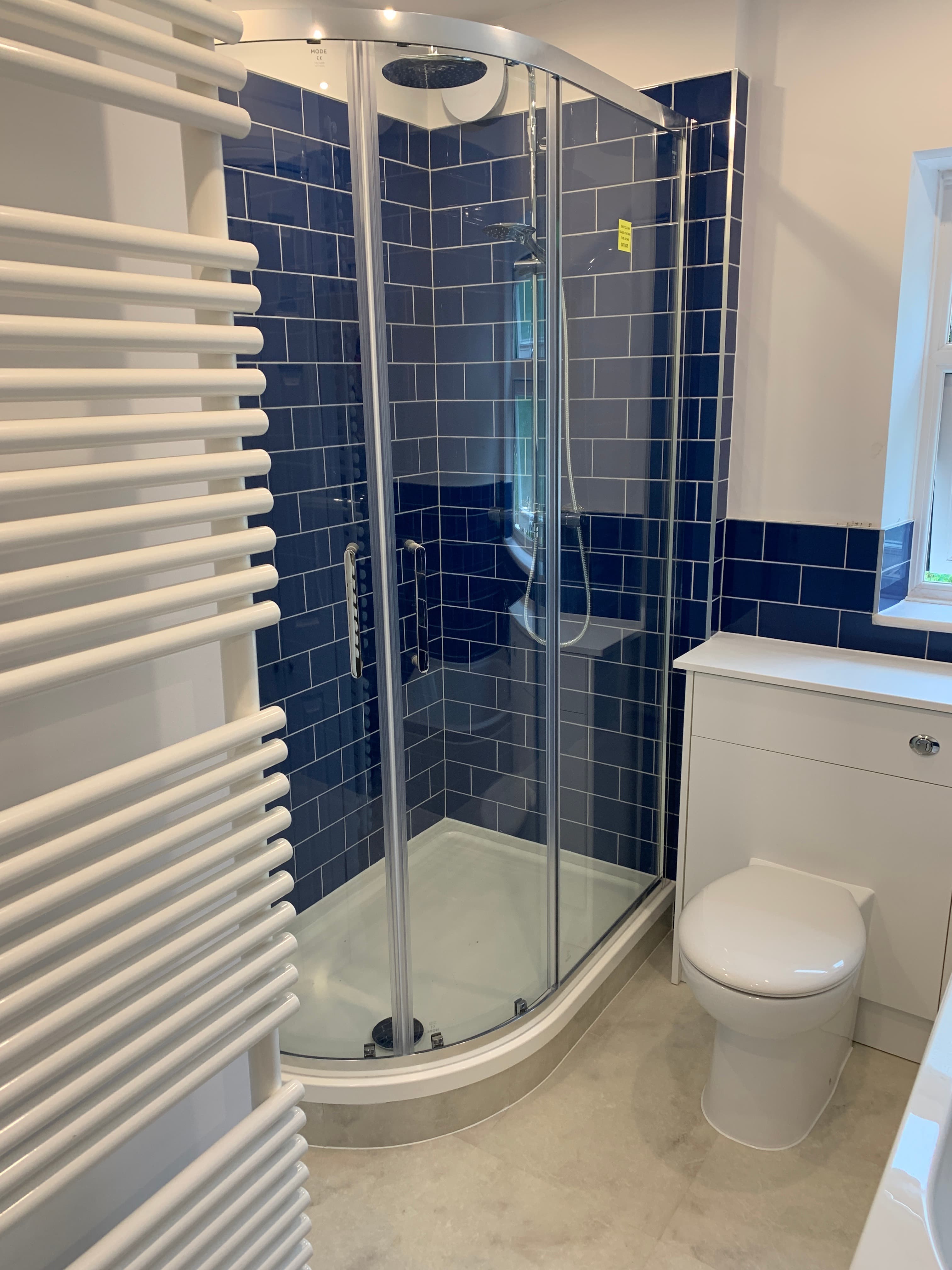 Quadrant shower enclosure with navy metro tiles