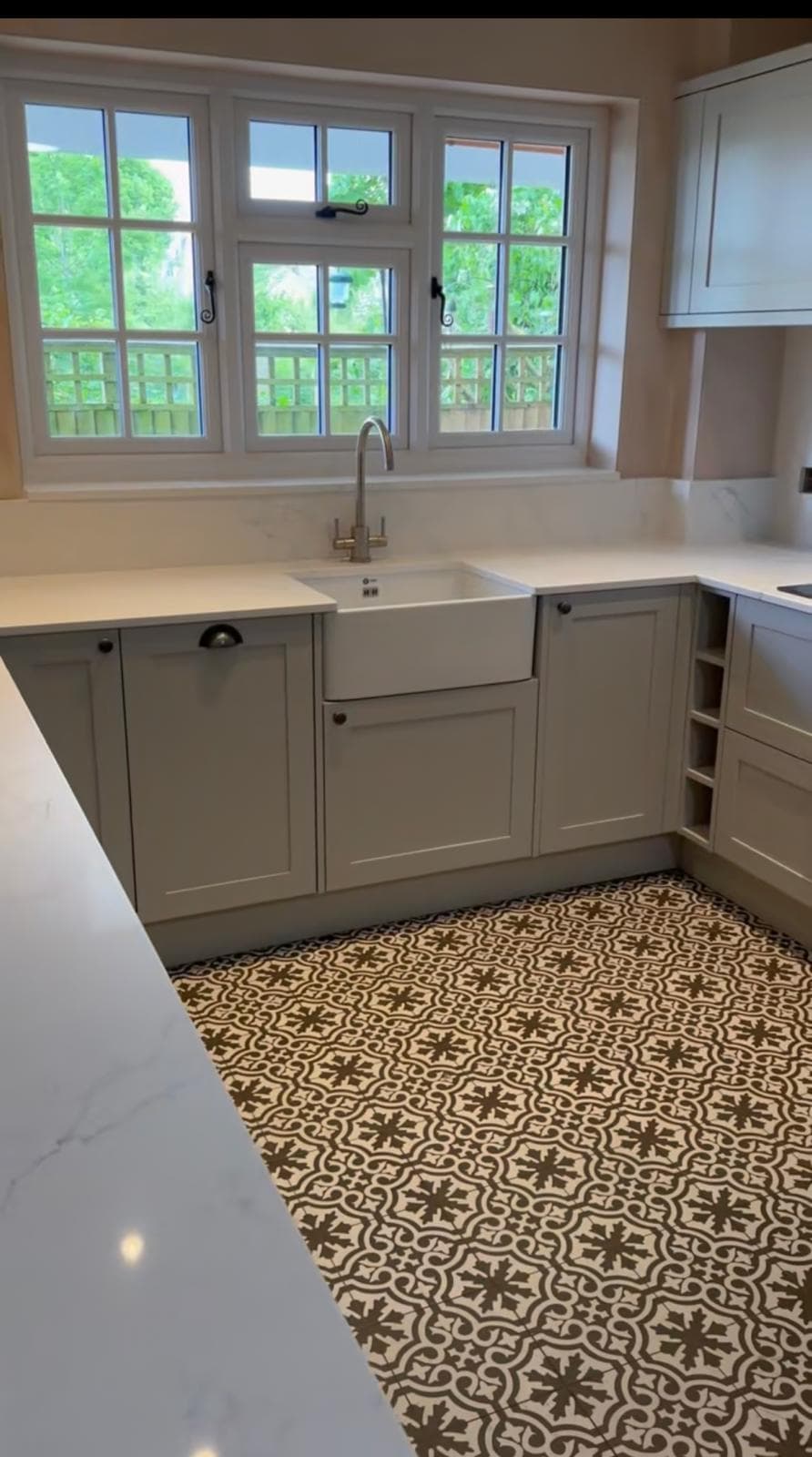 Belfast sink kitchen with patterned floor tiles