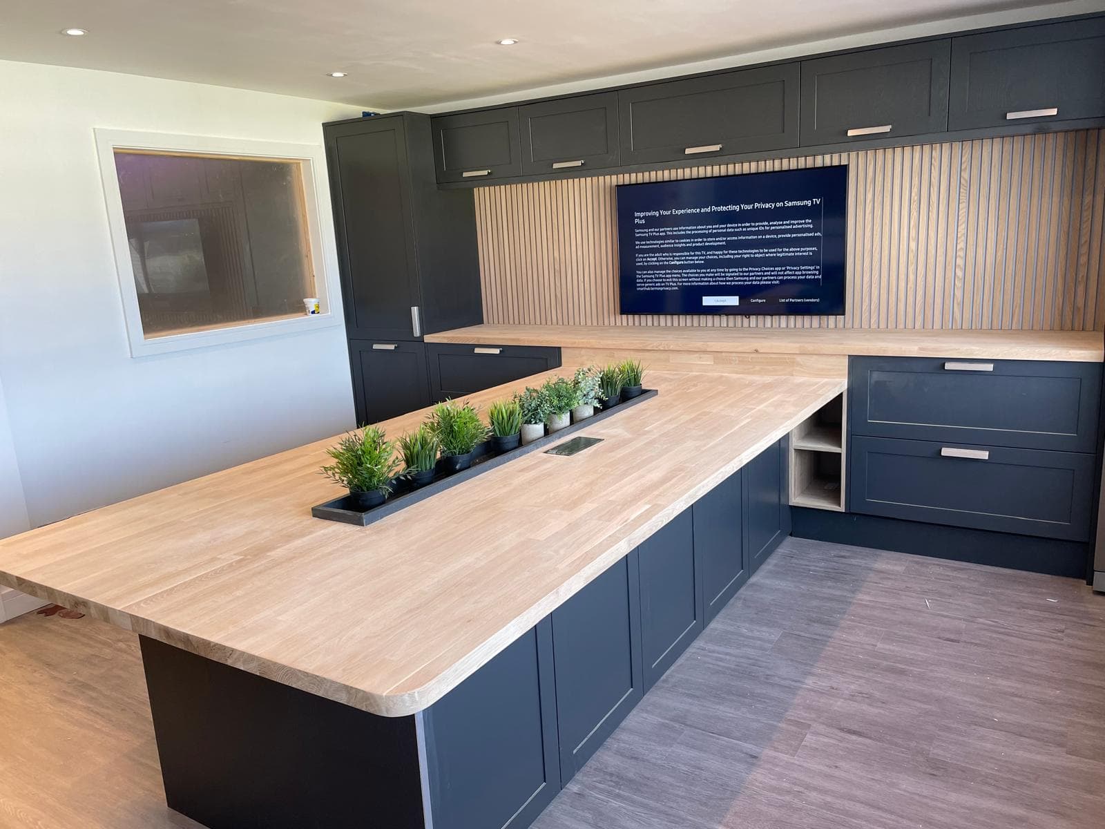 Navy kitchen with large island and oak worktop