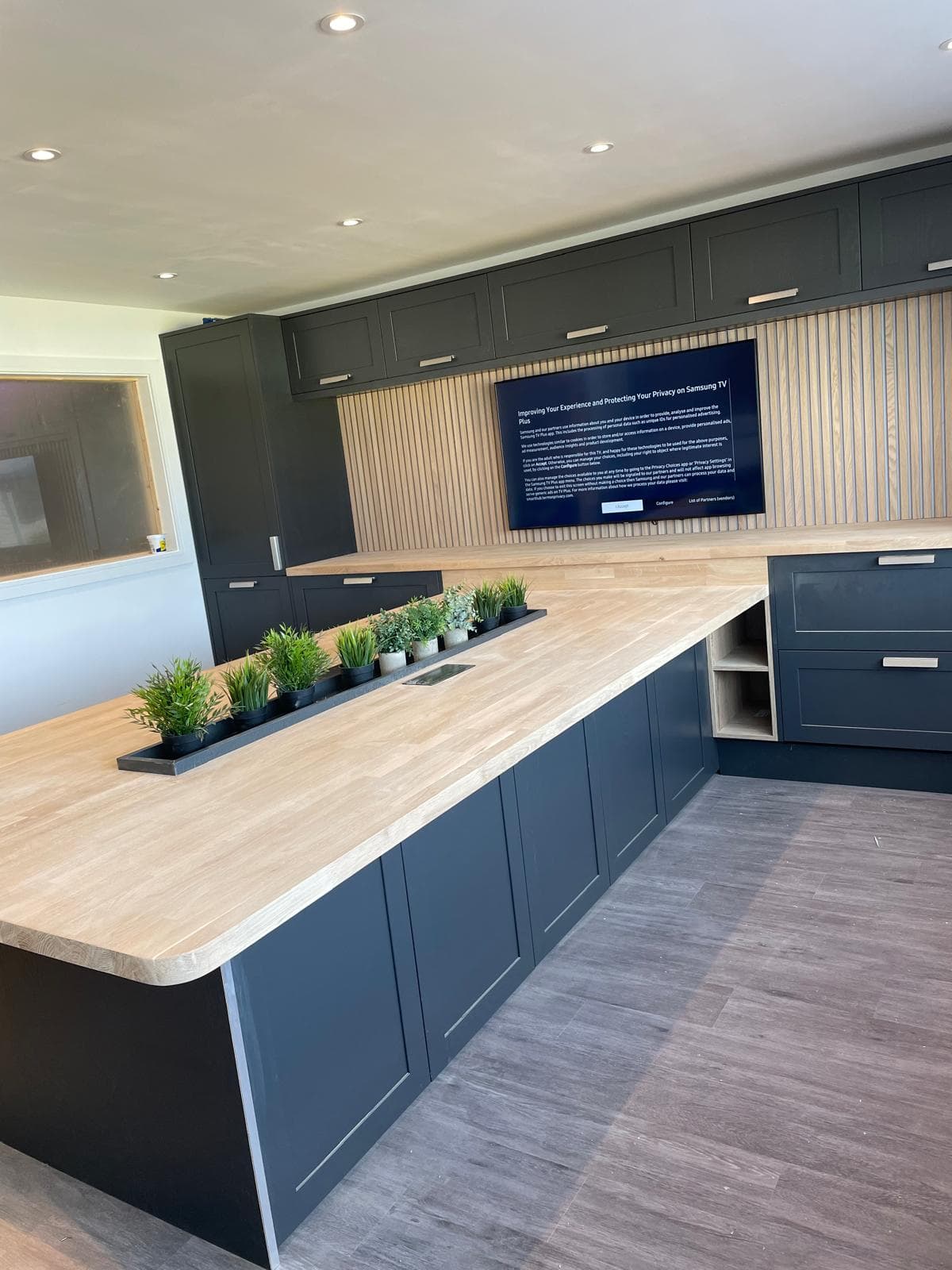 Navy kitchen island with oak worktop