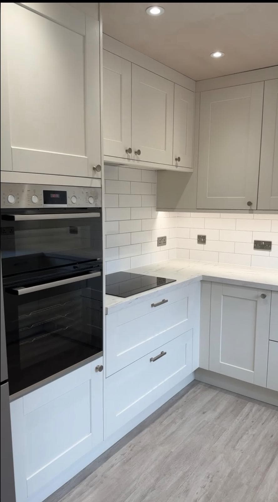 Light grey shaker kitchen with subway tile splashback